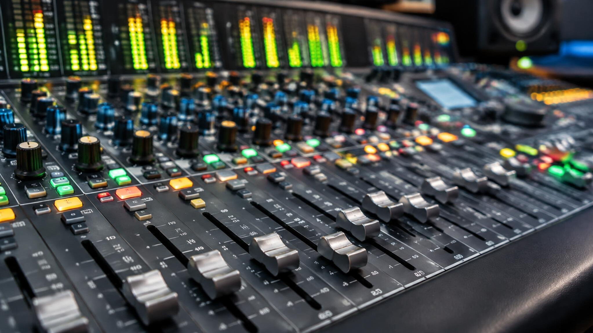 Audio mixing console with faders and knobs